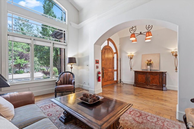 3149 E 9800 S, Sandy, UT 84092 - living room with arched walkways, plenty of natural light, hardwood / wood-style flooring, and a towering ceiling