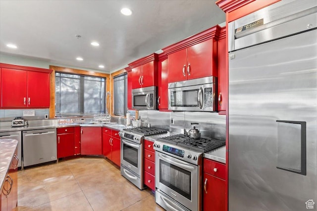 3149 E 9800 S, Sandy, UT 84092 - kitchen with stainless steel appliances, red cabinets, stainless steel countertops, decorative backsplash, and recessed lighting