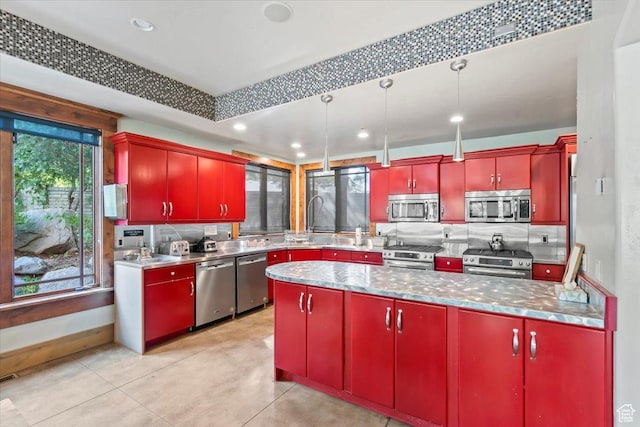 3149 E 9800 S, Sandy, UT 84092 - kitchen featuring appliances with stainless steel finishes, red cabinets, decorative backsplash, and recessed lighting