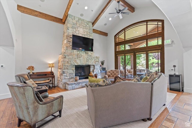 3149 E 9800 S, Sandy, UT 84092 - living room with beamed ceiling, high vaulted ceiling, ceiling fan, and a stone fireplace