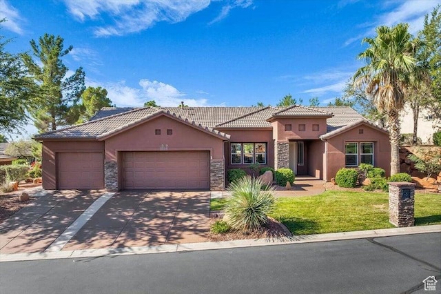1319 W Red Butte Dr W, Washington, UT 84780 - mediterranean / spanish home with stucco siding, stone siding, an attached garage, a tiled roof, and a front lawn