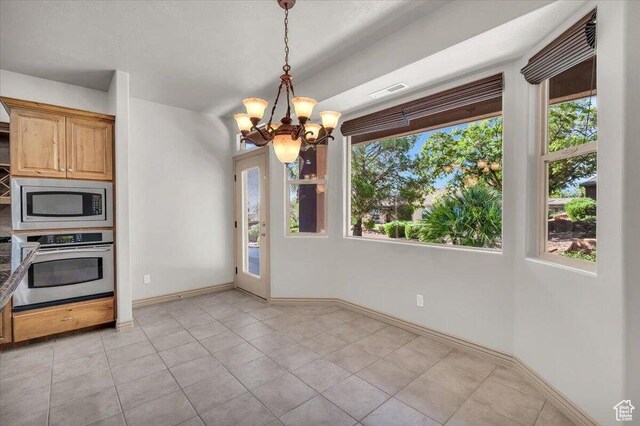 1319 W Red Butte Dr W, Washington, UT 84780 - kitchen featuring stainless steel appliances, a chandelier, light tile patterned floors, and pendant lighting