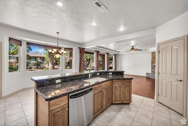 1319 W Red Butte Dr W, Washington, UT 84780 - kitchen featuring dishwasher, a textured ceiling, a chandelier, light tile patterned floors, and brown cabinets