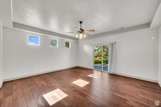 1319 W Red Butte Dr W, Washington, UT 84780 - unfurnished room with ceiling fan, a raised ceiling, wood-type flooring, and a textured ceiling