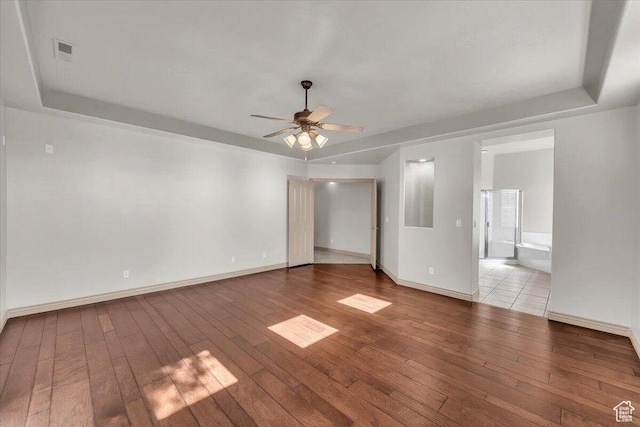 1319 W Red Butte Dr W, Washington, UT 84780 - empty room with wood-type flooring, ceiling fan, and a tray ceiling