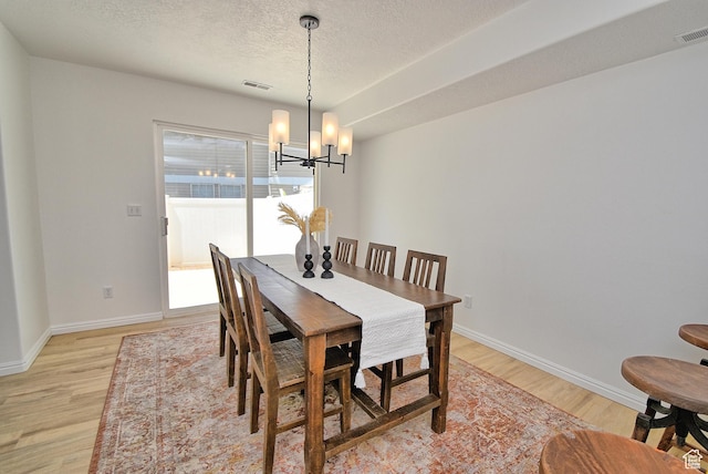 1323 S 1260 W, Orem, UT 84058 - dining room with light wood-type flooring, a chandelier, and a textured ceiling