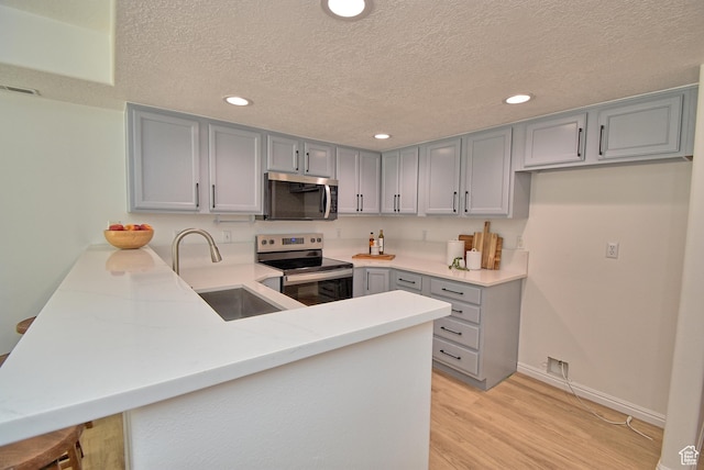 1323 S 1260 W, Orem, UT 84058 - kitchen featuring appliances with stainless steel finishes, gray cabinets, a peninsula, a textured ceiling, and recessed lighting