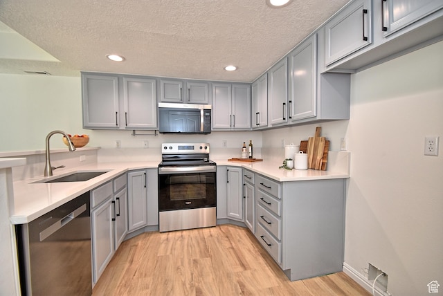 1323 S 1260 W, Orem, UT 84058 - kitchen featuring appliances with stainless steel finishes, gray cabinetry, recessed lighting, a peninsula, and light wood finished floors