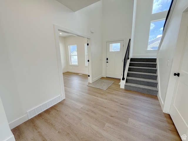 2237 E Parkside Cir S, South Ogden, UT 84403 - entryway with stairway, light wood finished floors, and a towering ceiling