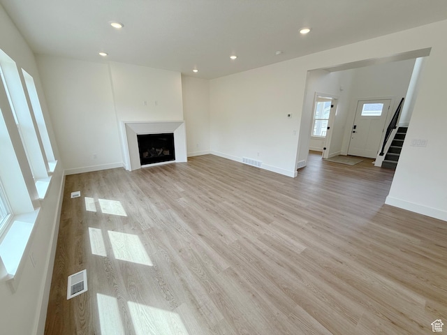2237 E Parkside Cir S, South Ogden, UT 84403 - unfurnished living room featuring light wood-style floors, stairway, recessed lighting, and a fireplace