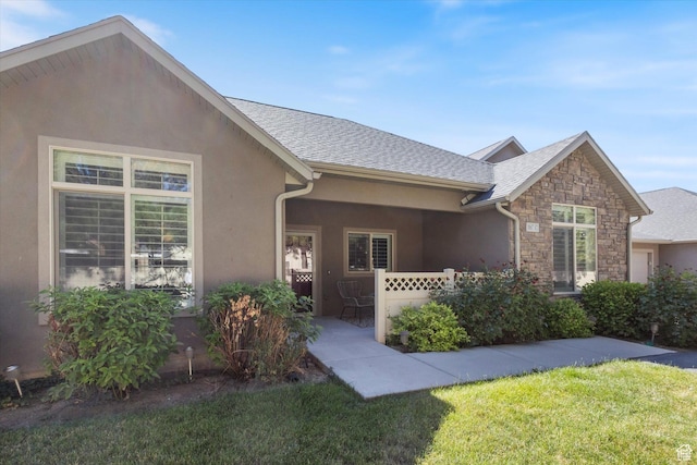 1867 W 9270 S Unit C, West Jordan, UT 84088 - view of front of house featuring a front yard, stucco siding, and stone siding