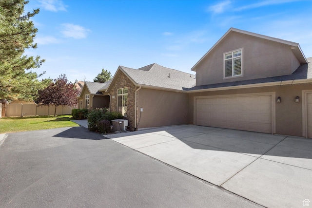 1867 W 9270 S Unit C, West Jordan, UT 84088 - view of property exterior with stucco siding, concrete driveway, and a garage