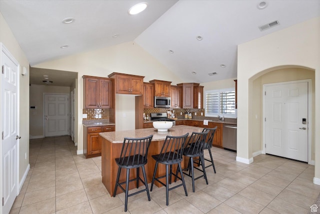 1867 W 9270 S Unit C, West Jordan, UT 84088 - kitchen featuring appliances with stainless steel finishes, backsplash, light tile patterned flooring, recessed lighting, and high vaulted ceiling