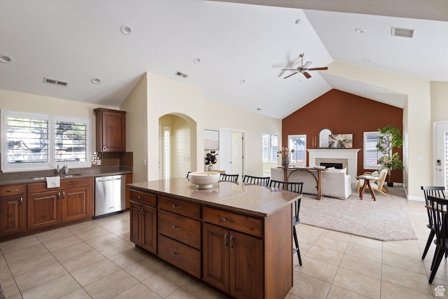 1867 W 9270 S Unit C, West Jordan, UT 84088 - kitchen featuring dishwasher, a ceiling fan, a breakfast bar area, light tile patterned flooring, and a center island