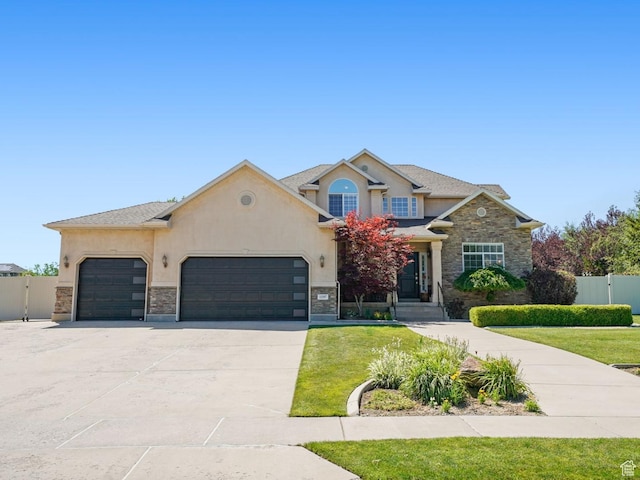 11597 N Sunset Hills Dr, Highland, UT 84003 - view of front facade with stucco siding, a garage, concrete driveway, stone siding, and a gate