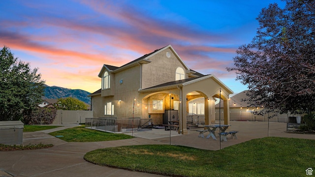 11597 N Sunset Hills Dr, Highland, UT 84003 - rear view of house with stucco siding, a patio area, and a gate
