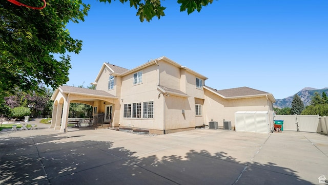 11597 N Sunset Hills Dr, Highland, UT 84003 - rear view of house with a gate, stucco siding, a patio area, a mountain view, and concrete driveway