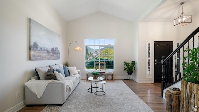 11597 N Sunset Hills Dr, Highland, UT 84003 - living room featuring stairway, wood finished floors, a chandelier, and vaulted ceiling