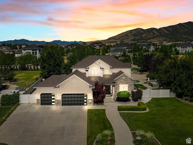 11597 N Sunset Hills Dr, Highland, UT 84003 - traditional home featuring stone siding, an attached garage, a mountain view, stucco siding, and concrete driveway