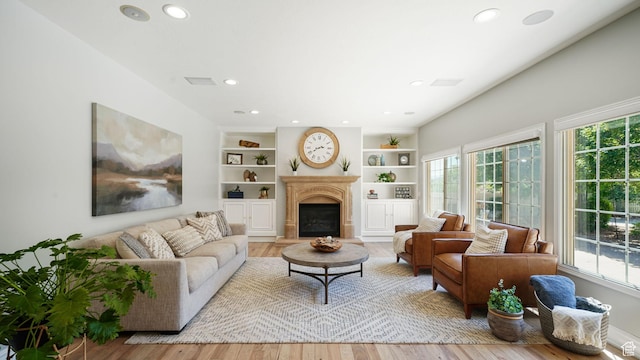 11597 N Sunset Hills Dr, Highland, UT 84003 - living room featuring recessed lighting, wood finished floors, a fireplace, and built in shelves
