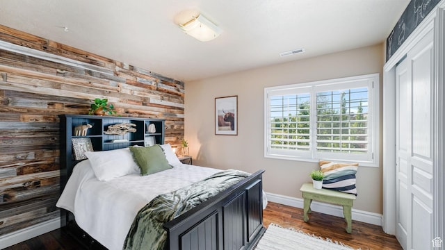 11597 N Sunset Hills Dr, Highland, UT 84003 - bedroom featuring wooden walls, wood finished floors, and a closet