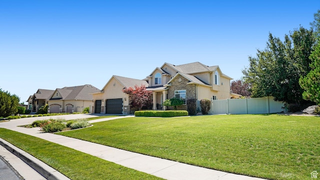 11597 N Sunset Hills Dr, Highland, UT 84003 - view of front of property with stone siding, stucco siding, an attached garage, concrete driveway, and a residential view