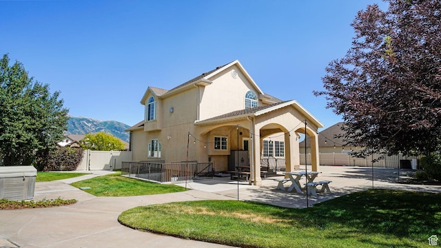 11597 N Sunset Hills Dr, Highland, UT 84003 - rear view of house featuring stucco siding, a patio area, a gate, and a mountain view