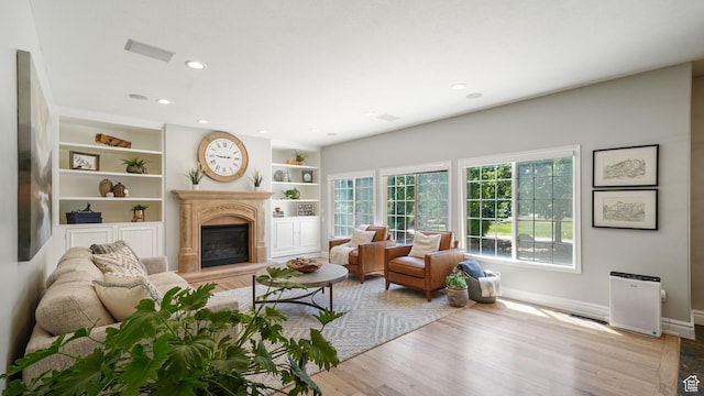 11597 N Sunset Hills Dr, Highland, UT 84003 - living area featuring a fireplace, recessed lighting, wood finished floors, and built in features