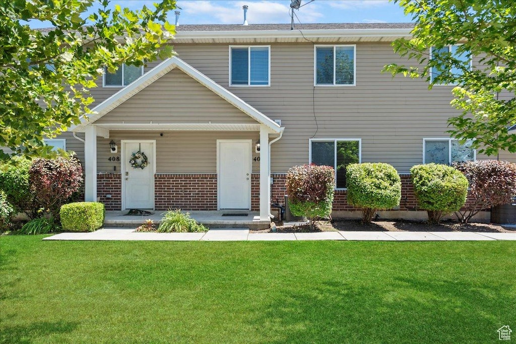 406 E 475 N, Ogden, UT 84404 - view of front of house featuring brick siding, a front lawn, and covered porch