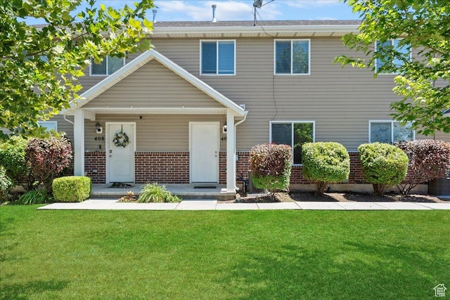 406 E 475 N, Ogden, UT 84404 - view of front of house featuring brick siding, a front lawn, and covered porch