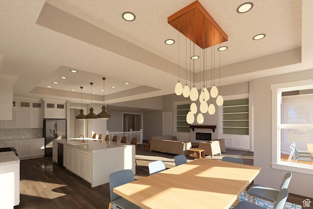 6158 W Silver Sky Dr W Unit 102, Herriman, UT 84096 - dining space featuring a tray ceiling, a fireplace, recessed lighting, dark wood-style flooring, and built in features