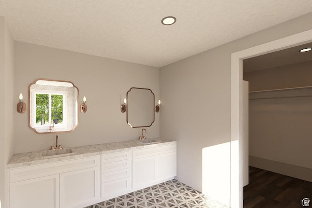 6158 W Silver Sky Dr W Unit 102, Herriman, UT 84096 - full bathroom with double vanity, a textured ceiling, a spacious closet, recessed lighting, and wood finished floors