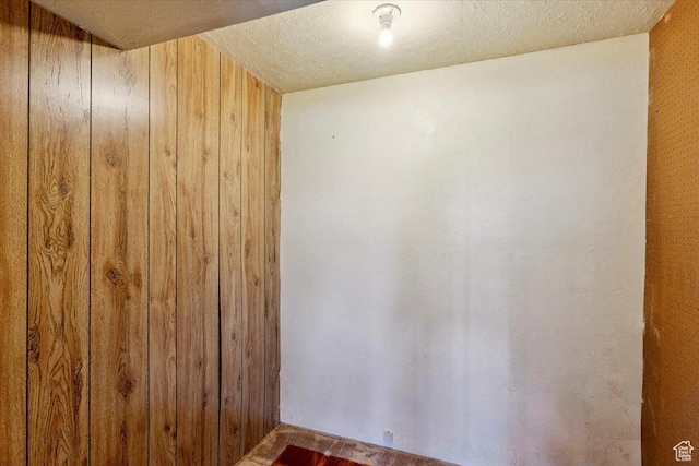 2989 W 700 S, Syracuse, UT 84075 - unfurnished room featuring wood walls and a textured ceiling
