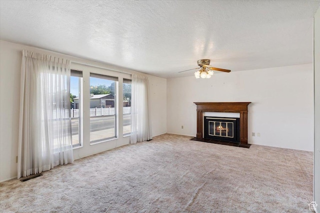 2989 W 700 S, Syracuse, UT 84075 - unfurnished living room featuring carpet, a ceiling fan, and a fireplace with flush hearth