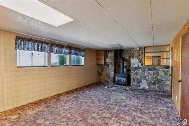 2989 W 700 S, Syracuse, UT 84075 - basement with a wood stove, carpet flooring, a drop ceiling, and wooden walls