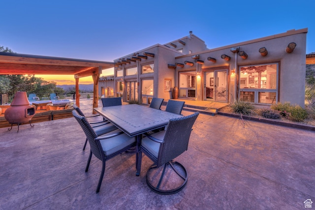 70 Desert Solitaire Rd, Moab, UT 84532 - patio terrace at dusk featuring a patio area and outdoor dining area