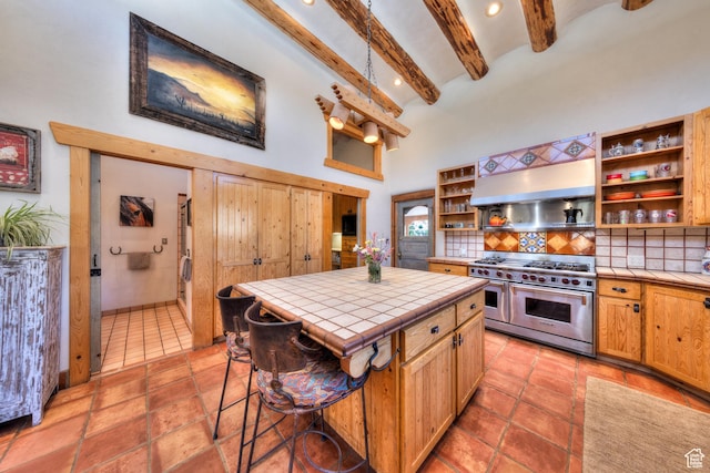 70 Desert Solitaire Rd, Moab, UT 84532 - kitchen featuring double oven range, tile counters, open shelves, range hood, and a towering ceiling