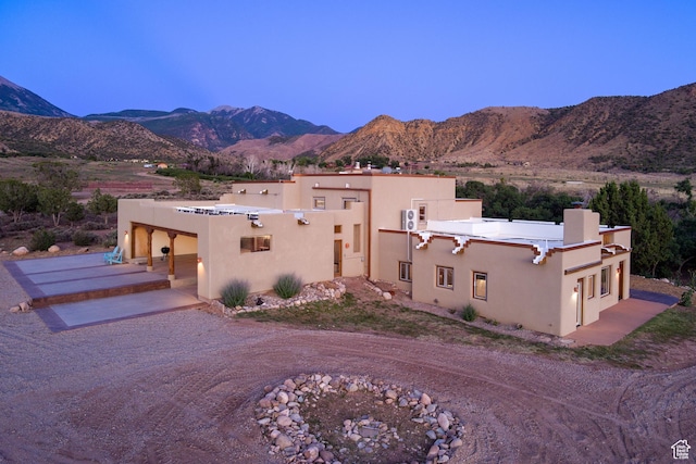 70 Desert Solitaire Rd, Moab, UT 84532 - view of front of home featuring stucco siding, a mountain view, and a chimney
