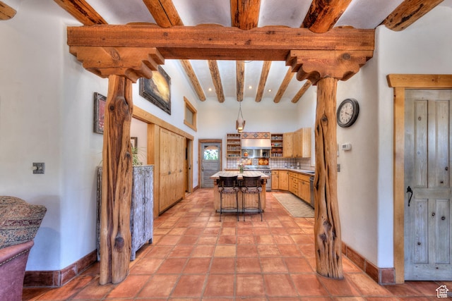 70 Desert Solitaire Rd, Moab, UT 84532 - kitchen with high end range, open shelves, beamed ceiling, a center island, and light countertops
