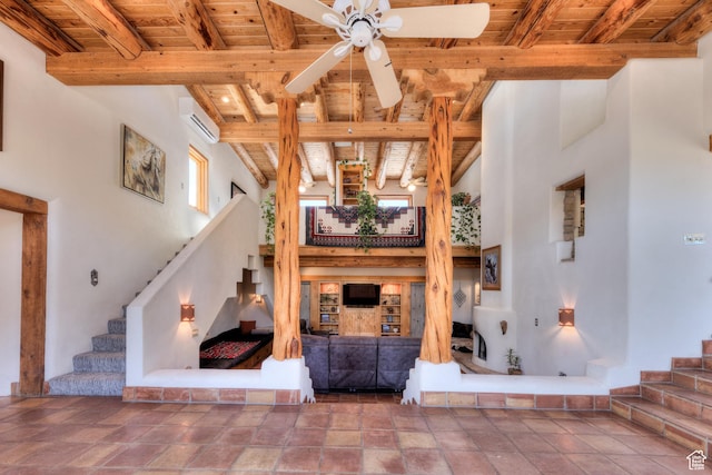 70 Desert Solitaire Rd, Moab, UT 84532 - living area featuring a wooden ceiling with exposed beams, a wall mounted AC, stairs, a ceiling fan, and stone finish flooring