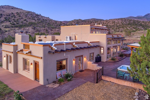 70 Desert Solitaire Rd, Moab, UT 84532 - mediterranean / spanish home with a mountain view, stucco siding, a patio, and a chimney