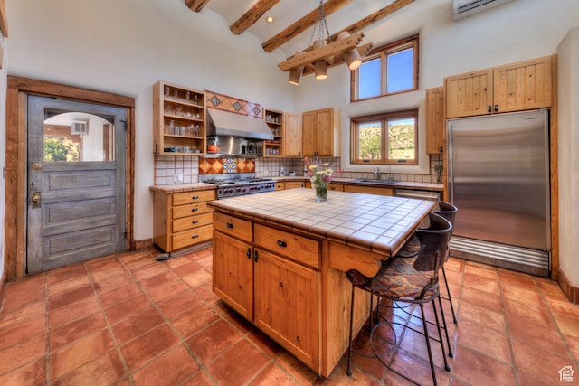 70 Desert Solitaire Rd, Moab, UT 84532 - kitchen featuring stainless steel built in refrigerator, under cabinet range hood, open shelves, tile countertops, and backsplash