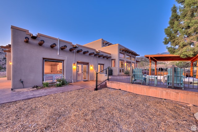 70 Desert Solitaire Rd, Moab, UT 84532 - rear view of house with a patio area and stucco siding