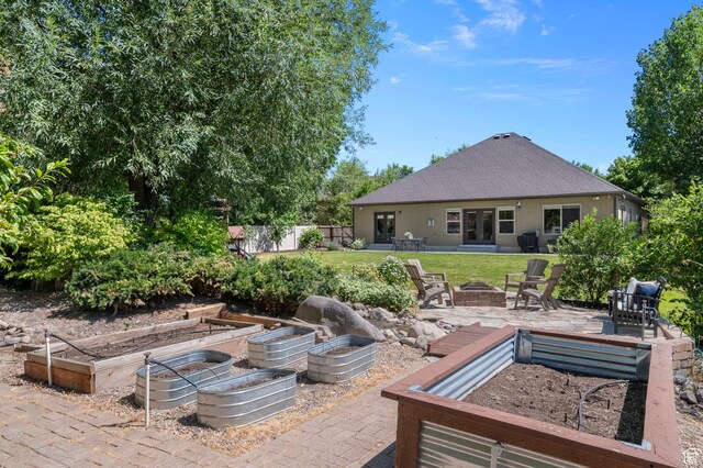 1066 W 575 N, Springville, UT 84663 - view of patio / terrace with a fire pit, a vegetable garden, and french doors