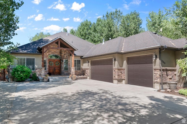 1066 W 575 N, Springville, UT 84663 - view of front facade featuring stone siding, an attached garage, concrete driveway, and stucco siding
