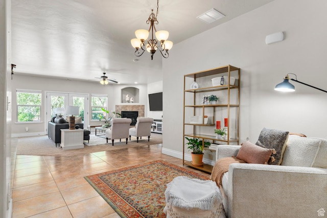 1066 W 575 N, Springville, UT 84663 - living area with light tile patterned floors, a ceiling fan, a fireplace, and a chandelier