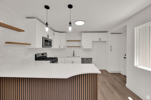 4243 W 5740 S, Salt Lake City, UT 84118 - kitchen with open shelves, appliances with stainless steel finishes, a peninsula, and decorative backsplash