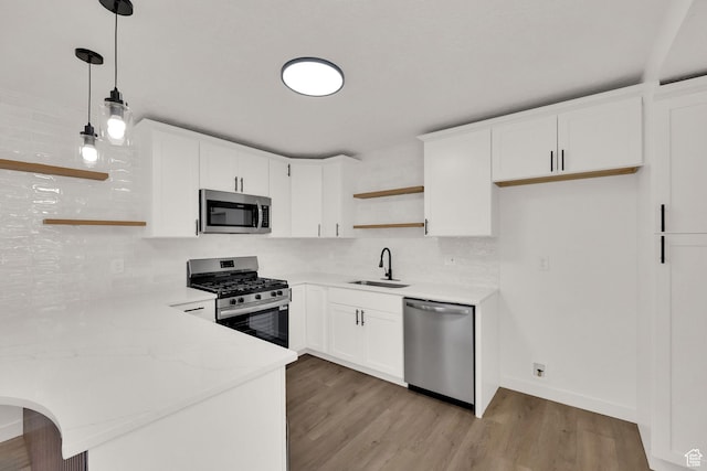 4243 W 5740 S, Salt Lake City, UT 84118 - kitchen featuring open shelves, appliances with stainless steel finishes, a peninsula, decorative backsplash, and light wood-style floors