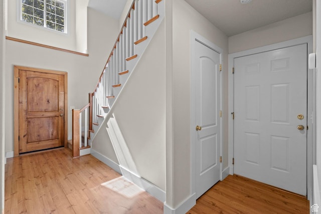 7861 N Tinamous Rd, Eagle Mountain, UT 84005 - entrance foyer with light wood-style flooring and stairway