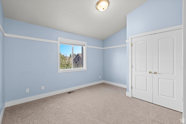 7861 N Tinamous Rd, Eagle Mountain, UT 84005 - unfurnished bedroom with carpet floors, vaulted ceiling, and a closet
